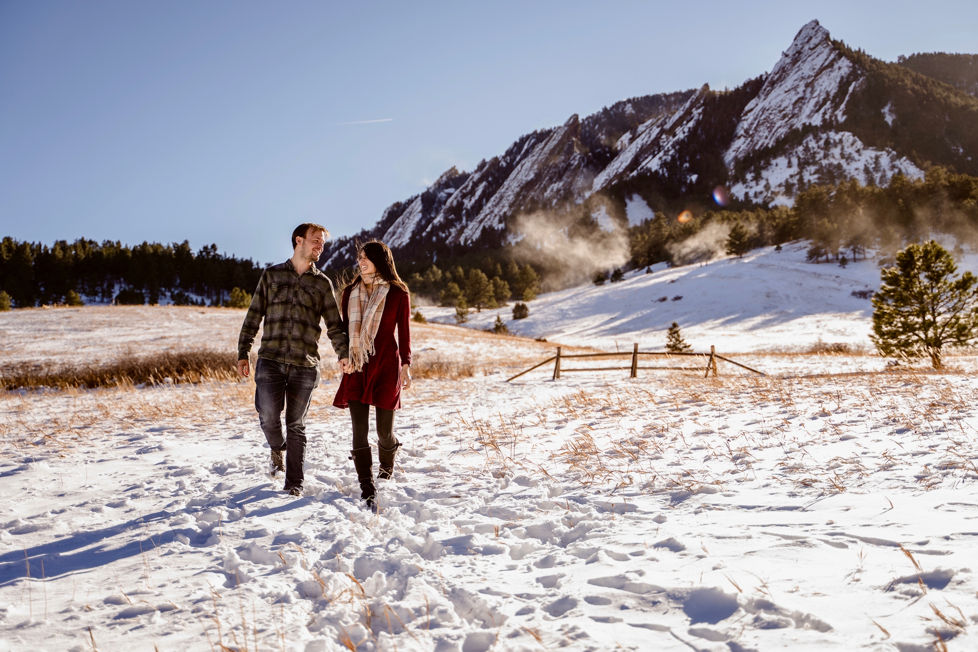 Paty and Matt walking and looking at each other with snowy flat-irons in the background