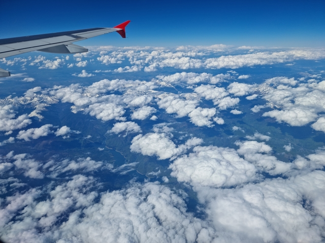 view of clouds outside plane window